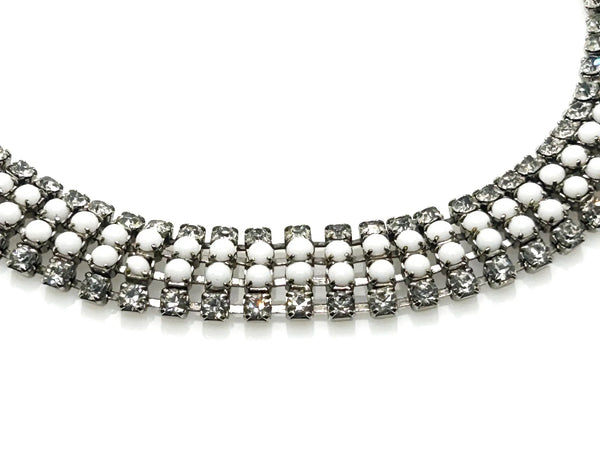 This dazzling choker brings serious sparkle to any outfit! Featuring creamy white milk glass cabochons paired with crystal-clear rhinestones, all nestled in a silvery mesh setting, it's pure vintage, subtle, glamour. 