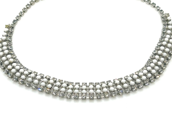 This dazzling choker brings serious sparkle to any outfit! Featuring creamy white milk glass cabochons paired with crystal-clear rhinestones, all nestled in a silvery mesh setting, it's pure vintage, subtle, glamour. 