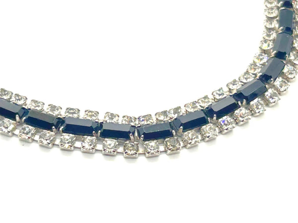 This is a beautiful vintage rhinestone necklace or choker set with a line of sideways baguettes in black paired with meticulously prong-set round white rhinestones on top and bottom.