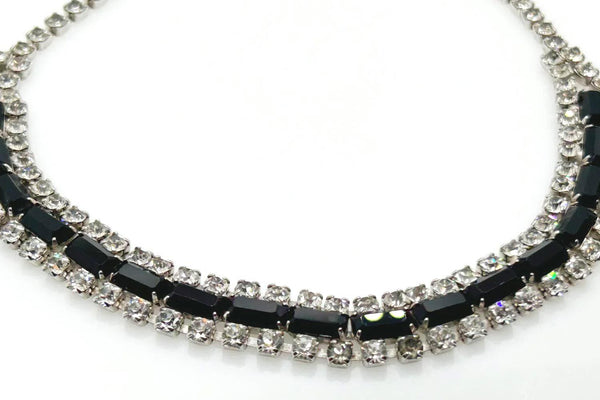 This is a beautiful vintage rhinestone necklace or choker set with a line of sideways baguettes in black paired with meticulously prong-set round white rhinestones on top and bottom.