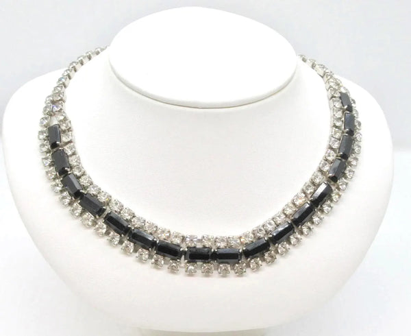 This is a beautiful vintage rhinestone necklace or choker set with a line of sideways baguettes in black paired with meticulously prong-set round white rhinestones on top and bottom.