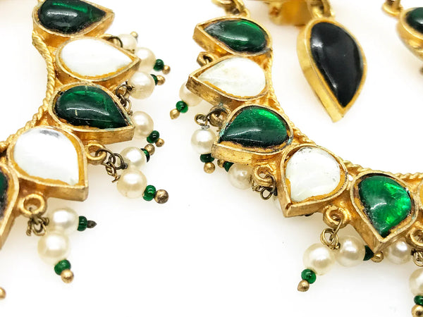Get ready to make a statement with a pair of stunning earrings that effortlessly combine legance of Moghul style and boldness. Each clip on earring features an alternating pattern of dramatic pear-shaped green and clear stones, along with a striking green drop that is beautifully accented with faux pearl and green beads. 