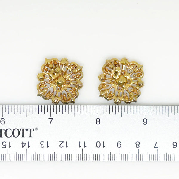 These filigreed vintage red earrings offer an exquisite aesthetic, beautifully detailed with pink, purple, and red chaton rhinestones in a square pattern. Meticulously designed, each earring's dimensions measure 3/4" square. 