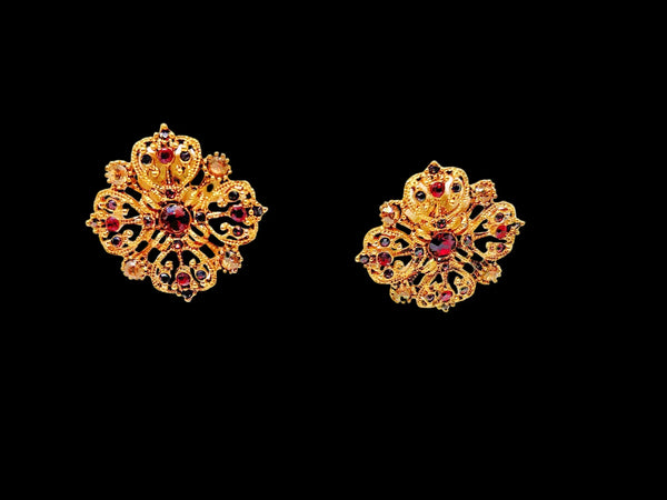 These filigreed vintage red earrings offer an exquisite aesthetic, beautifully detailed with pink, purple, and red chaton rhinestones in a square pattern. Meticulously designed, each earring's dimensions measure 3/4" square. 