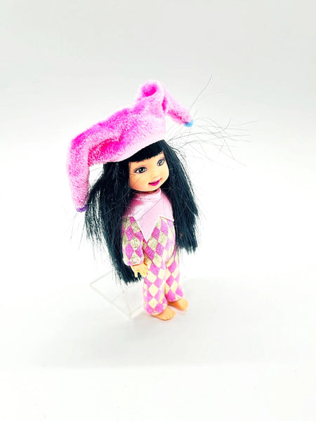 Jester Jenny doll wearing a pink and white checkered outfit with a matching hat on a white background