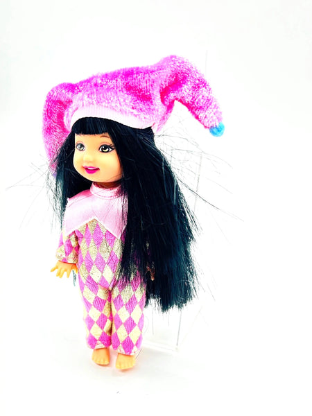 Jester Jenny doll wearing a pink and white checkered outfit with a matching hat on a white background