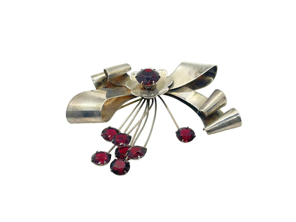 Perfect for vintage jewelry lovers: our Sterling by Jordan 1940s Red Stone Vintage Bow Brooch provides timeless elegance with striking red stones. Shop today!