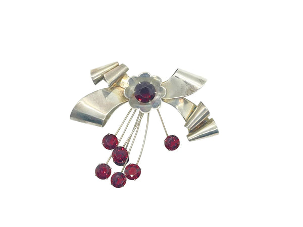 Perfect for vintage jewelry lovers: our Sterling by Jordan 1940s Red Stone Vintage Bow Brooch provides timeless elegance with striking red stones. Shop today!