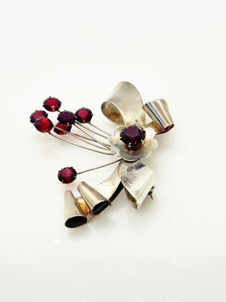 Perfect for vintage jewelry lovers: our Sterling by Jordan 1940s Red Stone Vintage Bow Brooch provides timeless elegance with striking red stones. Shop today!