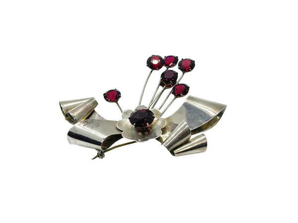 Perfect for vintage jewelry lovers: our Sterling by Jordan 1940s Red Stone Vintage Bow Brooch provides timeless elegance with striking red stones. Shop today!