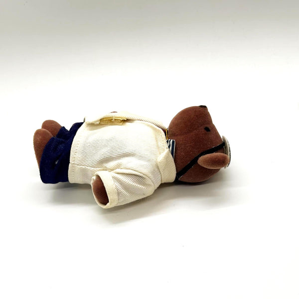 A small brown plush teddy bear dressed up as a medical doctor