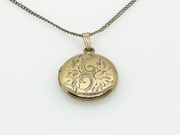 This timeless piece from the late 1960s features carefully engraved detailing on the front and a sleek, polished back. The locket has enough space for two treasured photos or any other keepsake of your choice