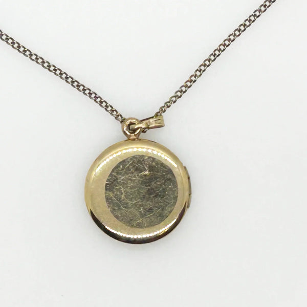 This timeless piece from the late 1960s features carefully engraved detailing on the front and a sleek, polished back. The locket has enough space for two treasured photos or any other keepsake of your choice