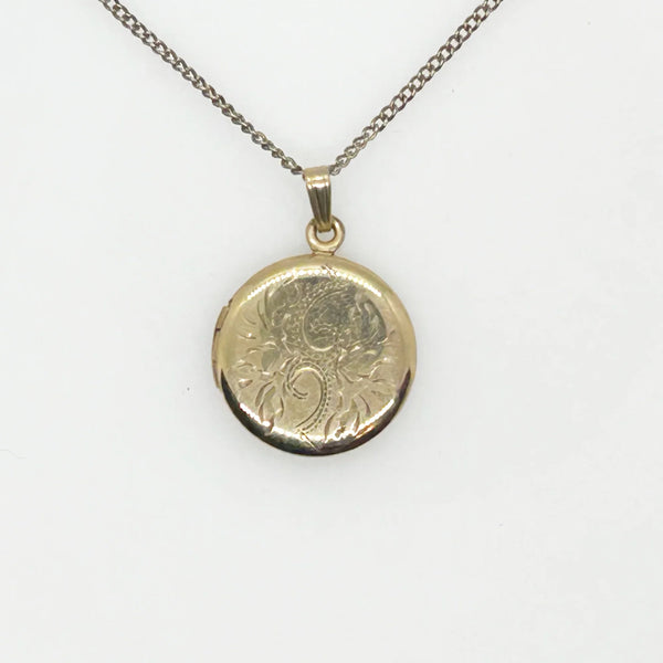 This timeless piece from the late 1960s features carefully engraved detailing on the front and a sleek, polished back. The locket has enough space for two treasured photos or any other keepsake of your choice