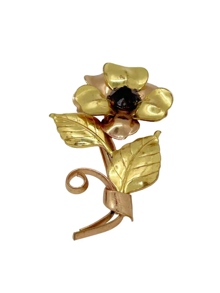Bring a touch of vintage glamour to any outfit with this stunning, handmade flower brooch. Its beautifully crafted copper and gold petals and leaves surround a sparkling purple center, making it a striking statement piece that will surely turn heads.