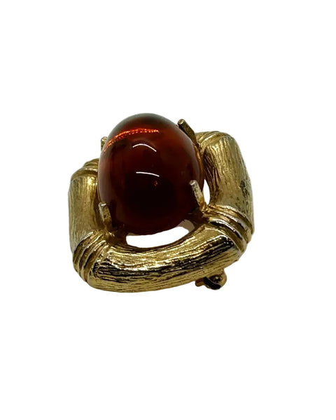 Indulge in the warm, honeyed glow of this delightful Les Bernard brooch. Rich amber glass catches the light like liquid caramel, nestled within a brushed gold-tone squared setting that frames it to perfection.