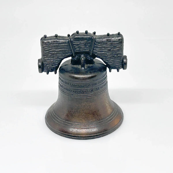 Bring a touch of American history to your home with this charming, miniature metal replica of the iconic Liberty Bell. Standing at a delightful 2.5 inches tall, this piece beautifully captures the essence of freedom and independence, a symbol that has resonated since the American Revolution.