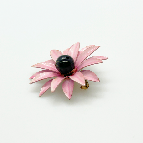 Bring a splash of retro charm to your collection with this delightful 1960s mod brooch! Featuring vibrant pink enamel petals arranged in a bold daisy design, it captures the spirit of the flower power movement that defined the swinging sixties. Shop Now!