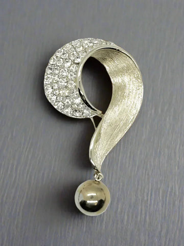 Get ready for all eyes to be on you with this Vintage 4" Purple Question Mark Brooch. From the 1930s, it features varying shades of purple, lavender, and amethyst. This brooch is a true statement piece. The silver tone metal sets off the unique shapes, each prong set for added dimension.