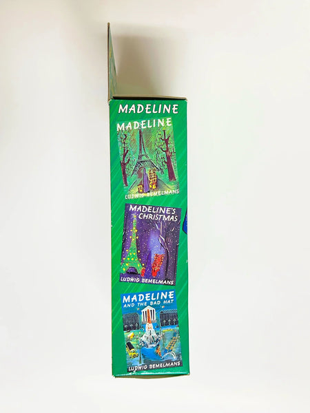 From Eden Toys, Inc., comes this 8" poseable Madeline doll, complete with her school dress, blue coat, socks, shoes, pantes and iconic yellow hat. night clothes. Attention to detail shows in the appendix scar described in the books and fully combable hair. She also has a change of night clothes, a blue nightgown and white slippers.