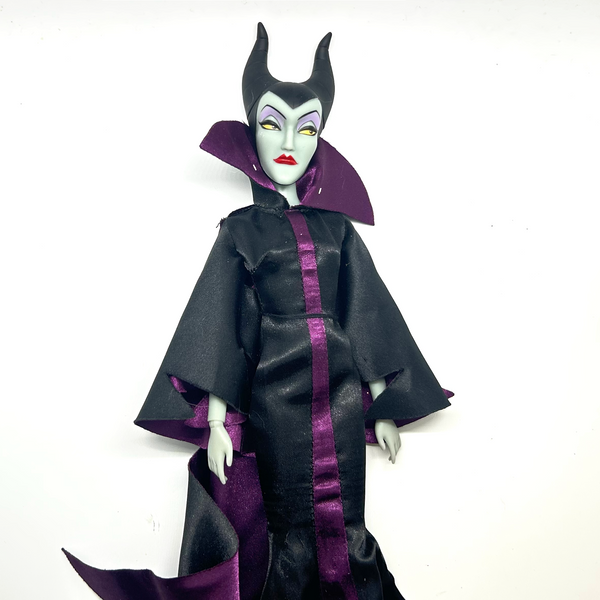 Disney Store Maleficent 12-inch classic fashion doll wearing her iconic black and burgundy robe with curved horns headpiece, isolated on a solid white background.