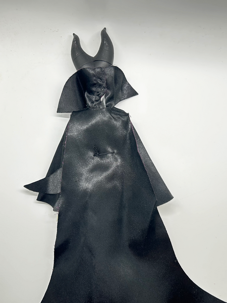 Disney Store Maleficent 12-inch classic fashion doll wearing her iconic black and burgundy robe with curved horns headpiece, isolated on a solid white background.