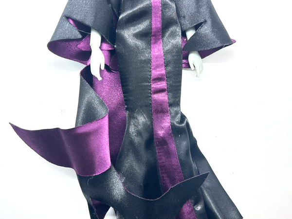 Disney Store Maleficent 12-inch classic fashion doll wearing her iconic black and burgundy robe with curved horns headpiece, isolated on a solid white background.