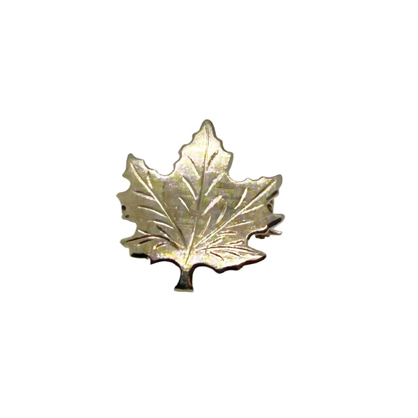 Add a touch of vintage charm to your wardrobe with this delightful silver maple leaf pin! This little beauty- measuring just 1" across- showcases intricate etching that brings the iconic leaf to life, complete with a textured finish that catches the light beautifully.