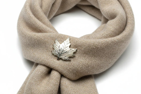 Add a touch of vintage charm to your wardrobe with this delightful silver maple leaf pin! This little beauty- measuring just 1" across- showcases intricate etching that brings the iconic leaf to life, complete with a textured finish that catches the light beautifully.