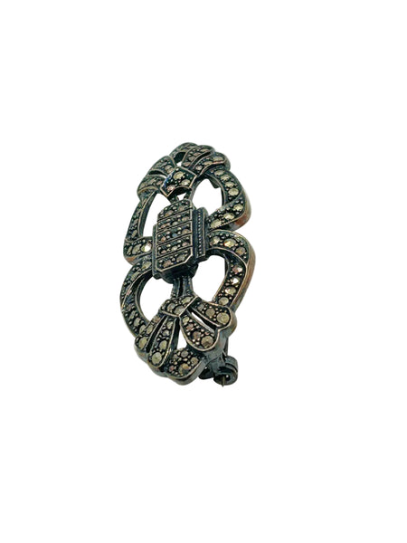 Vintage Art Deco sterling silver bar brooch featuring an openwork geometric design inlaid with shimmering marcasite stones, isolated on a white background.