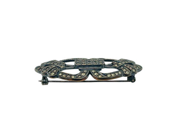 Vintage Art Deco sterling silver bar brooch featuring an openwork geometric design inlaid with shimmering marcasite stones, isolated on a white background.