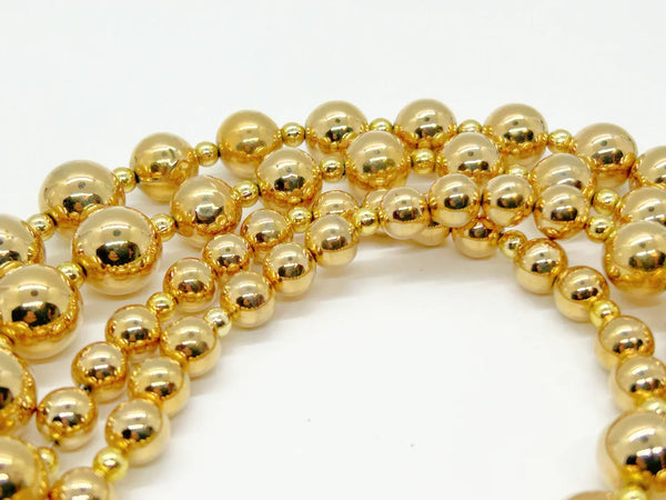 Striking and Dramatic, this gold bead double strand necklace is signed Marvella and measures 25” and 26" with a hook clasp, slight wear to clasp