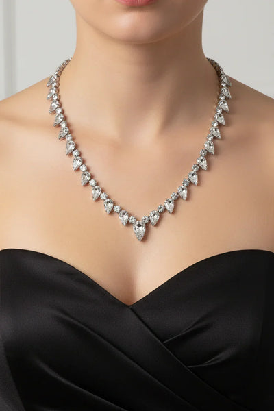 Discover the magic of this stunning vintage Superb Kramer Rhinestone Necklace, where icy brilliance meets timeless elegance. Adorned with crystal-clear marquise and pear-cut stones nestled in gleaming rhodium-plated silver-tone metal, this 14.5" beauty practically dances with light.