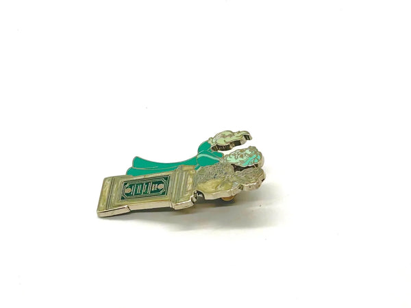 This pin is a 2012 Disney Parks Walt Disney World Haunted Mansion Interactive Graveyard Queue "Cousin Maude and Uncle Jacob's Statue" mystery pin.