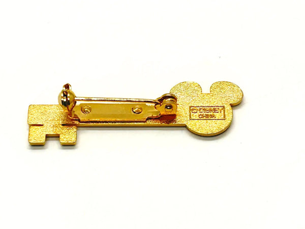 This enchanting gold-tone pin celebrates one of Disney's most exclusive experiences! This is a gold-tone souvenir pin given to guests who take the "Keys to the Kingdom" backstage walking tour at Magic Kingdom in Walt Disney World.