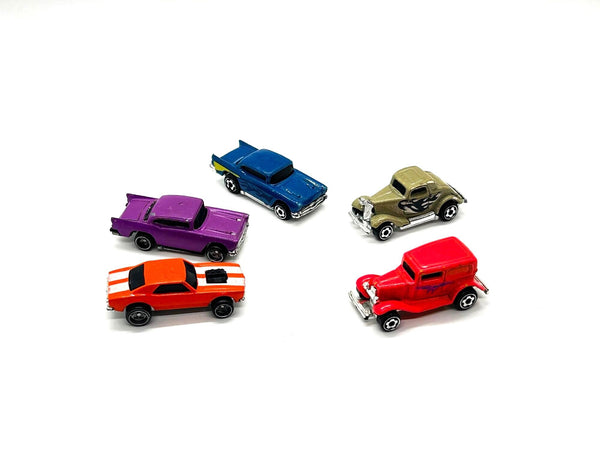 Five miniature toy cars in various colors including purple, blue, gold, orange, and red, arranged on a plain white background.