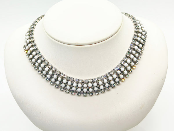 This dazzling choker brings serious sparkle to any outfit! Featuring creamy white milk glass cabochons paired with crystal-clear rhinestones, all nestled in a silvery mesh setting, it's pure vintage, subtle, glamour