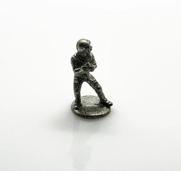 These are pewter tokens from a NFL Collector's Edition of the Monopoly board game, such as the 1998 or 2004 version.;The set includes miniature pewter figures of football players, a cheerleader, a football helmet, a football, and a whistle. I believe they were the Seattle Seahawks version.They are popular replacement parts for enthusiasts collecting specific themed Monopoly sets.