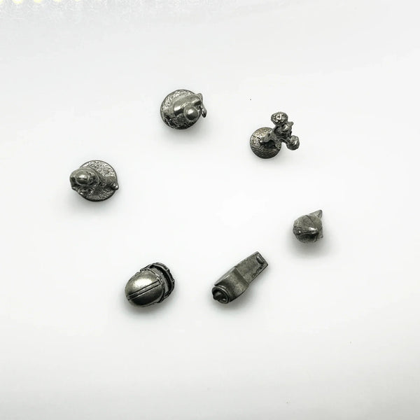 These are pewter tokens from a NFL Collector's Edition of the Monopoly board game, such as the 1998 or 2004 version.;The set includes miniature pewter figures of football players, a cheerleader, a football helmet, a football, and a whistle. I believe they were the Seattle Seahawks version.They are popular replacement parts for enthusiasts collecting specific themed Monopoly sets.
