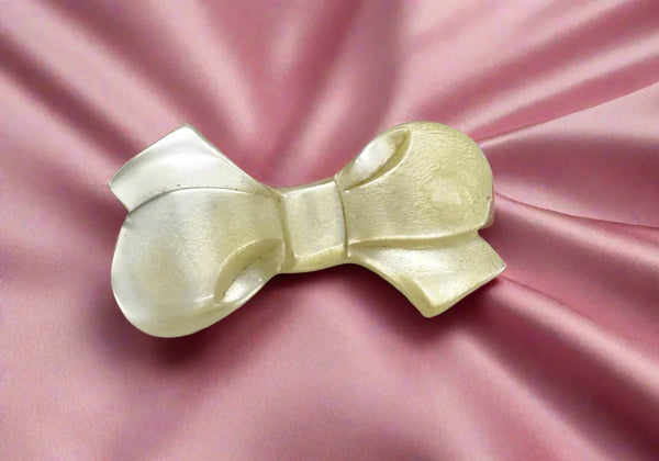 Make a statement with this elegant bow brooch! Its unique design is sure to turn heads and add a touch of glamour to any outfit. At 2.5 inches, this brooch is the perfect size to make a subtle yet stunning statement