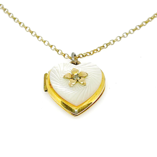 Mother of Pearl Heart Locket Necklace - Timeless vintage locket with a mother-of-pearl face and enamel flower detail. Heart-shaped and perfect for keepsakes. Shop now!