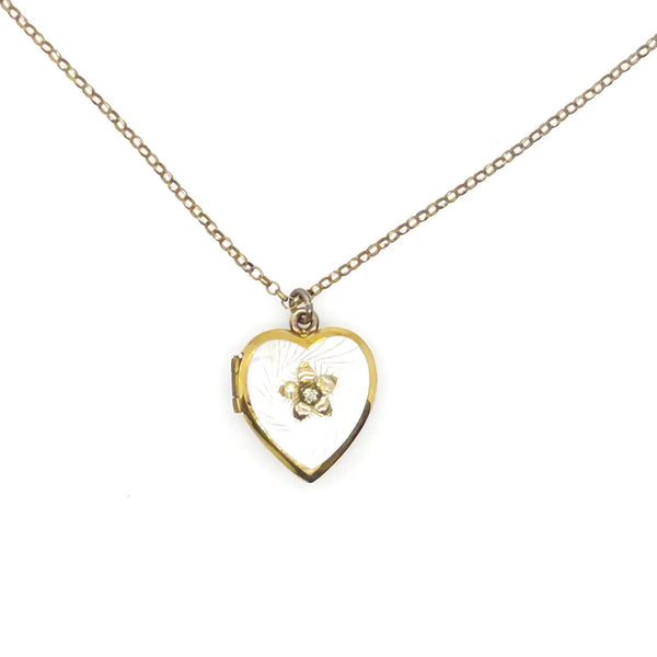 Mother of Pearl Heart Locket Necklace - Timeless vintage locket with a mother-of-pearl face and enamel flower detail. Heart-shaped and perfect for keepsakes. Shop now!
