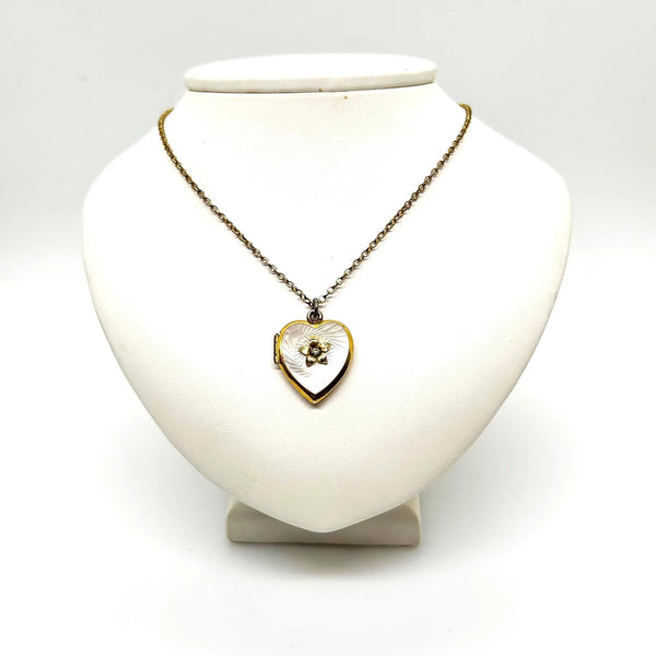 Mother of Pearl Heart Locket Necklace - Timeless vintage locket with a mother-of-pearl face and enamel flower detail. Heart-shaped and perfect for keepsakes. Shop now!