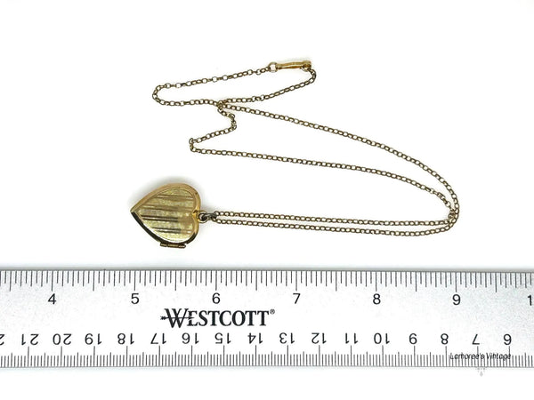 Mother of Pearl Heart Locket Necklace - Timeless vintage locket with a mother-of-pearl face and enamel flower detail. Heart-shaped and perfect for keepsakes. Shop now!