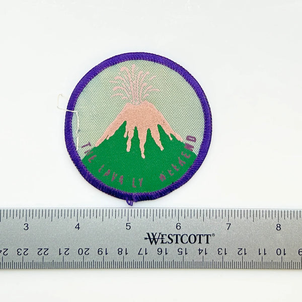 Commemorate a pivotal moment in natural history with this authentic Girl Scout Mount St. Helens patch from the early 1980s. Created in the wake of the volcano's catastrophic 1980 eruption, this Junior Girl Scout badge captures the dramatic geological event through embroidery—a volcano erupting in shades of pink against a serene blue-green sky.