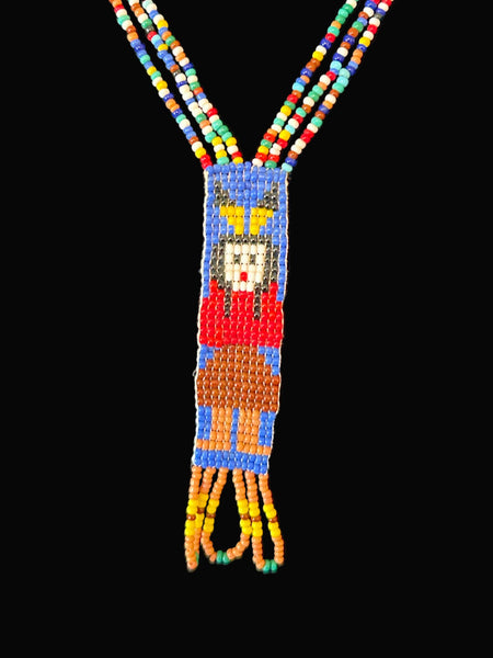 This is a striking example of vintage Native American-style hand-beaded necklace, featuring a loom-woven pendant of a female figure. These necklaces are handcrafted using colorful glass seed beads and often include traditional design elements such as looped fringe detail. These pieces are generally created using a flat, loom-woven technique.