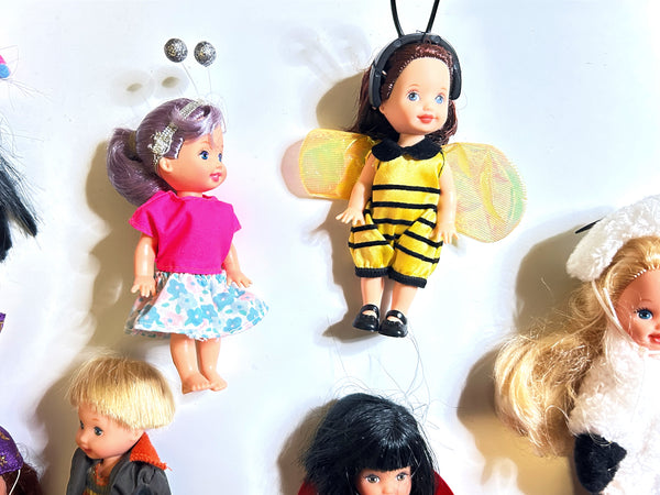 Collector lot of early 2000s Mattel Barbie Kelly Club 4-inch mini dolls, including the 2001 Garden Series Bumblebee Melody doll in costume and a purple-haired friend doll with a floral skirt