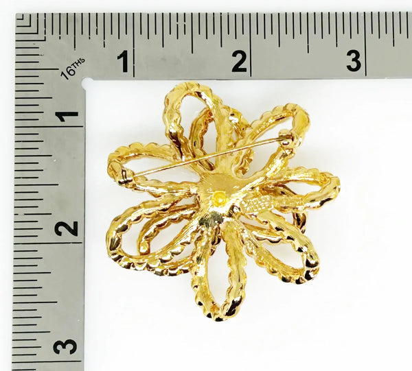Discover a rare glamour brooch by Nolan Miller, a super sparkly 3D ribbon design in rich gold metal with bright clear stones. Free shipping included!
