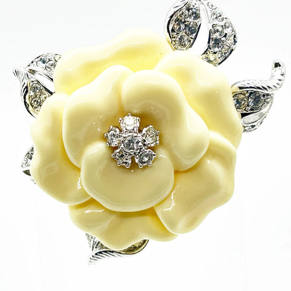 Perfect for those who appreciate timeless glamour: our Nolan Miller Lara Camellia Brooch provides a creamy flower brooch with sparkling elegance. Shop today!