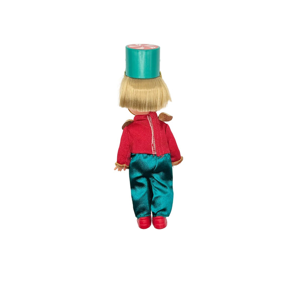 Rear full-length view of a 4-inch Mattel Kelly Club doll dressed as a Nutcracker soldier on a clean white background
